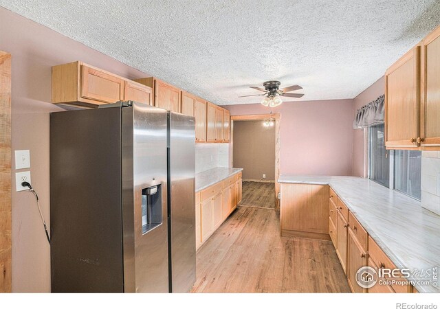 kitchen featuring stainless steel fridge with ice dispenser, ceiling fan, light hardwood / wood-style floors, light brown cabinets, and a textured ceiling