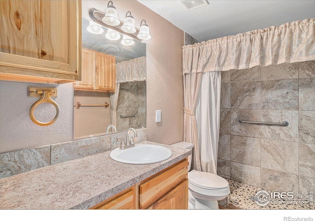 bathroom with vanity, toilet, and walk in shower