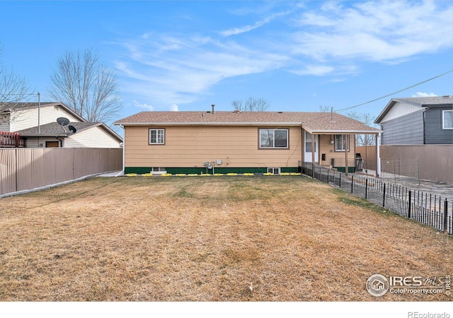 rear view of house with a yard