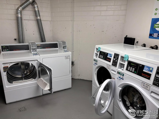 clothes washing area with washer and clothes dryer