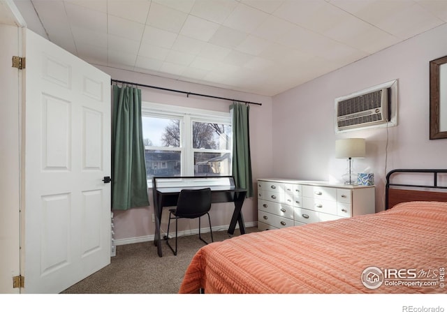 carpeted bedroom with a wall mounted AC and baseboards