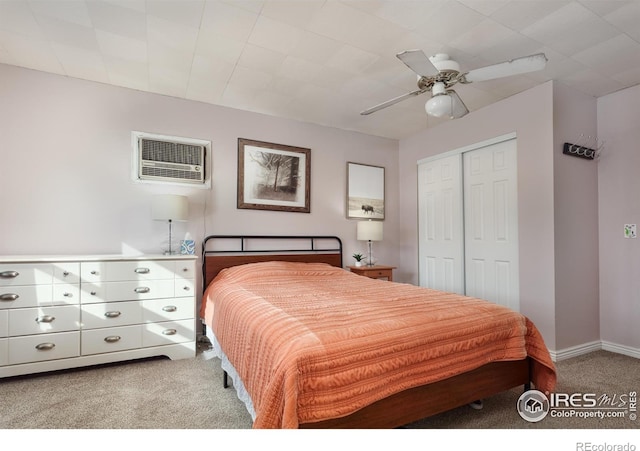 bedroom featuring carpet, a closet, a ceiling fan, an AC wall unit, and baseboards