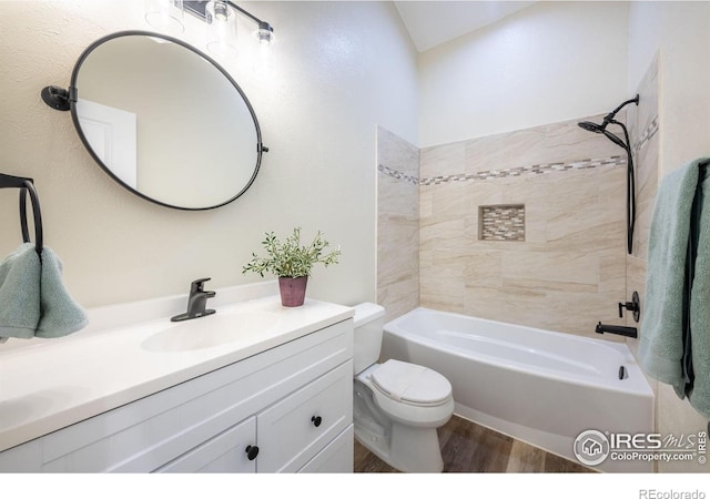 full bath featuring toilet, shower / washtub combination, wood finished floors, and vanity