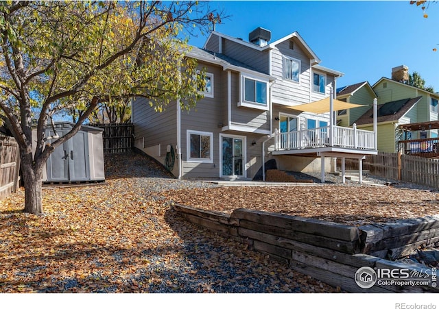 back of property featuring an outbuilding, a storage shed, and a fenced backyard