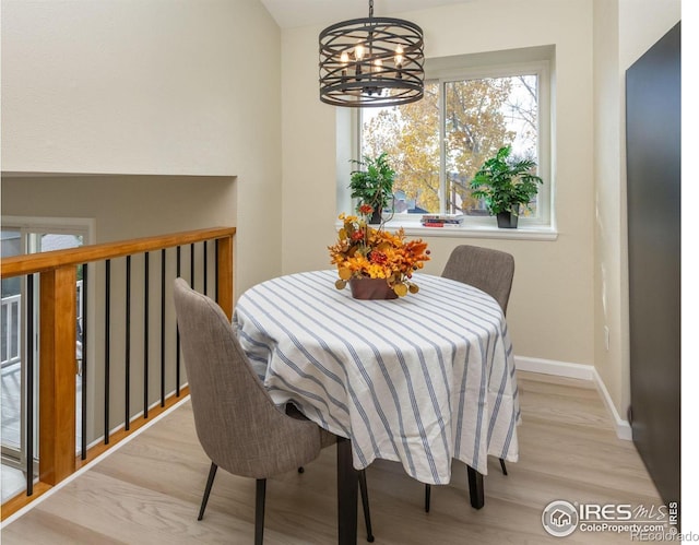 dining area with an inviting chandelier, wood finished floors, and baseboards