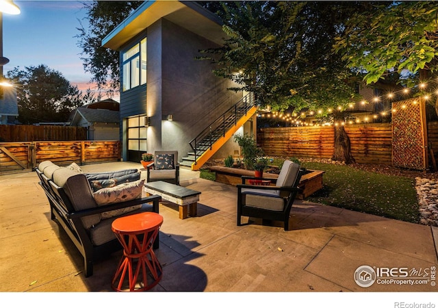 patio terrace at dusk with an outdoor living space