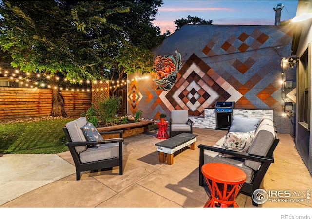 patio terrace at dusk featuring grilling area