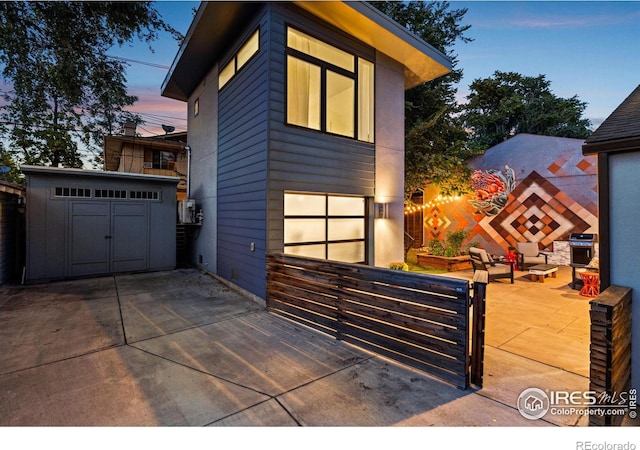 modern home featuring an outbuilding and a patio