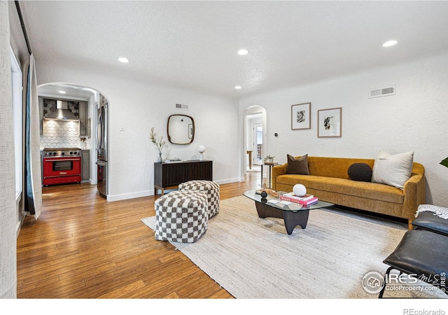 living room with hardwood / wood-style floors and a textured ceiling