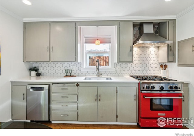 kitchen with wall chimney range hood, sink, dishwasher, stove, and ornamental molding