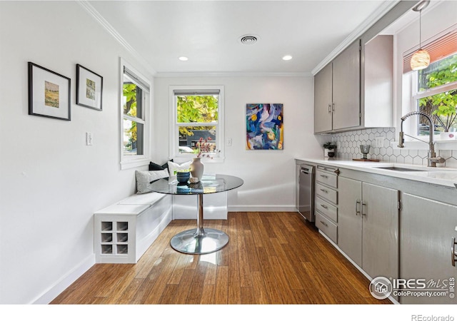 kitchen with breakfast area, sink, hanging light fixtures, and gray cabinetry