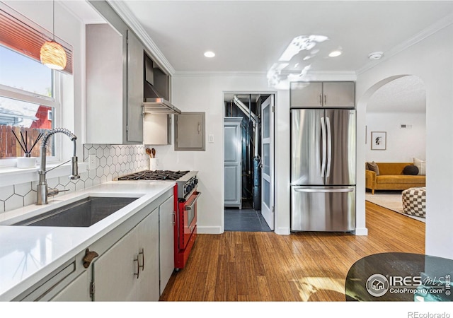 kitchen featuring sink, range with gas cooktop, decorative light fixtures, stainless steel refrigerator, and gray cabinets