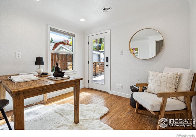 office area with light hardwood / wood-style floors