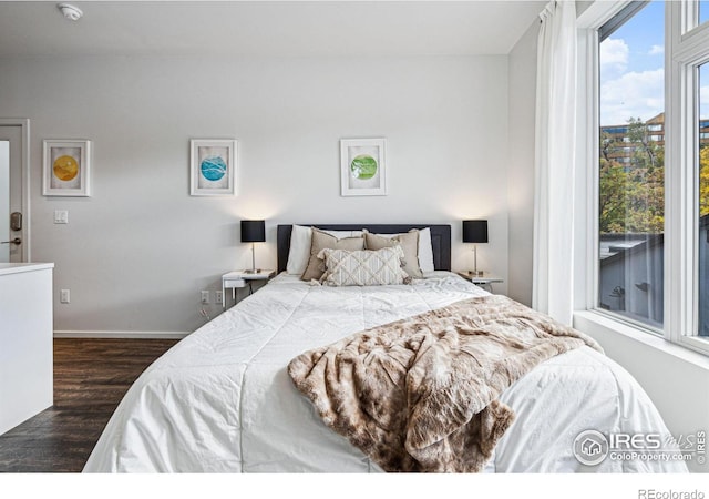 bedroom with dark wood-type flooring and access to exterior