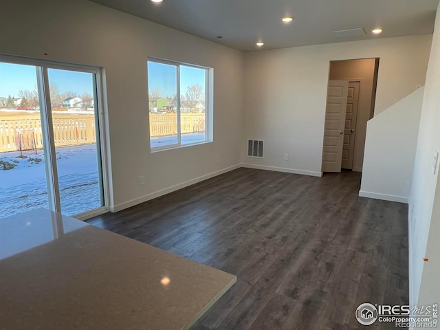 spare room featuring dark wood-type flooring