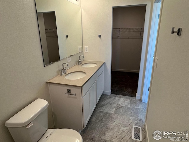 bathroom with vanity and toilet