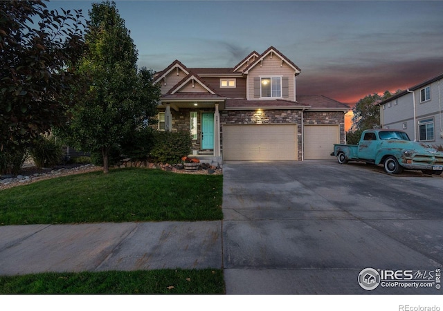 view of front of home featuring a garage and a lawn