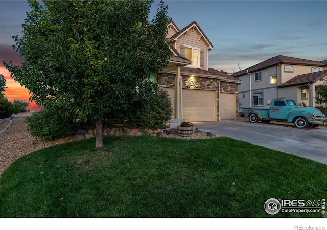 obstructed view of property featuring a garage and a yard