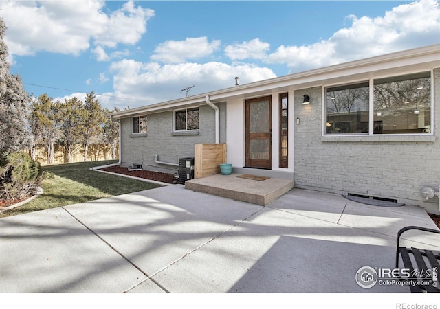 exterior space featuring a patio area and a lawn