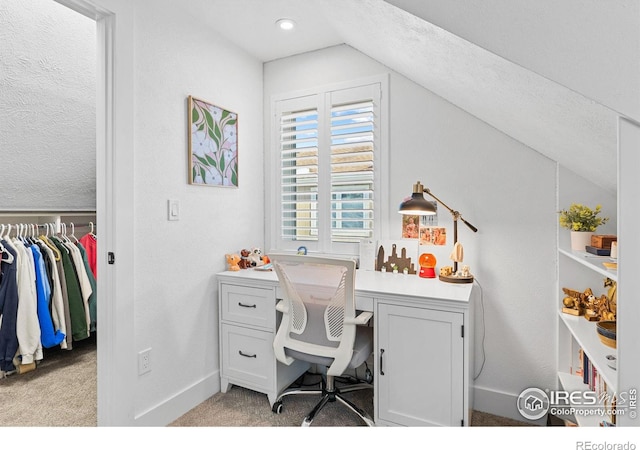 office featuring lofted ceiling and light colored carpet