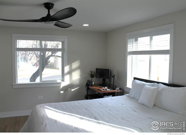 bedroom with hardwood / wood-style floors and ceiling fan