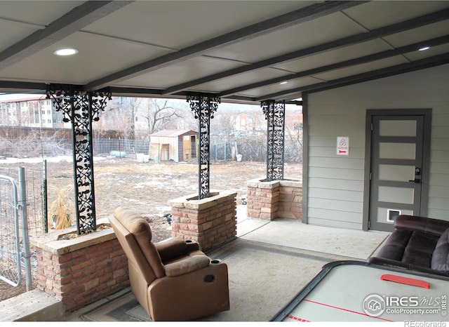 view of patio featuring a storage unit