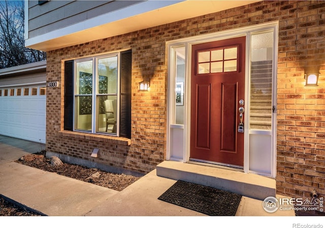 view of exterior entry with a garage