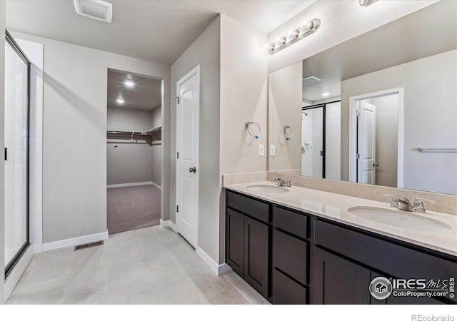 bathroom with vanity, tile patterned floors, and walk in shower