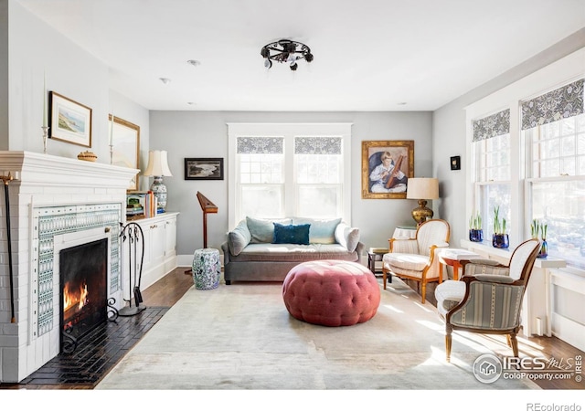 living room featuring a brick fireplace