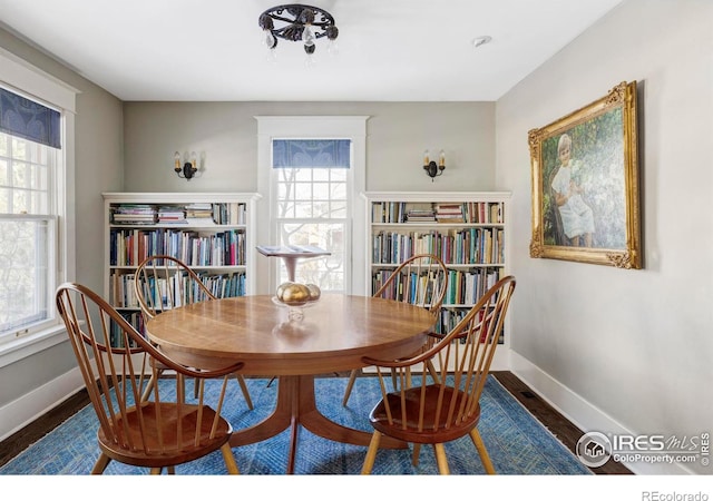 dining space featuring dark hardwood / wood-style floors