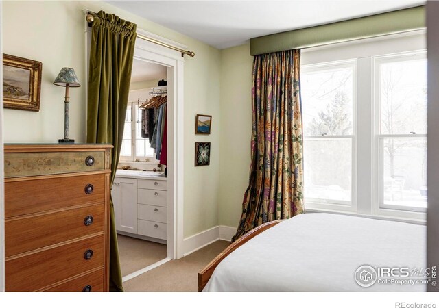 carpeted bedroom with ensuite bath