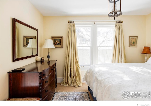 bedroom featuring light colored carpet