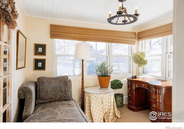 living area featuring carpet and an inviting chandelier