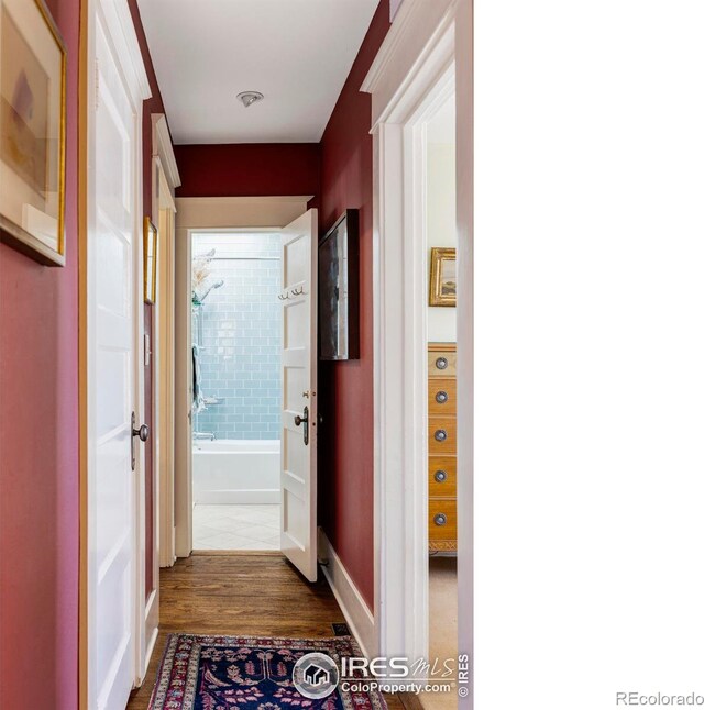 hallway with hardwood / wood-style flooring