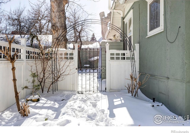 view of snow covered gate