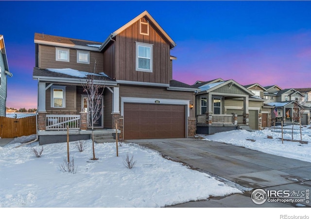 craftsman inspired home with a garage and a porch