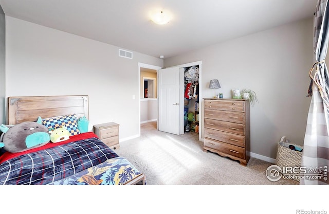 bedroom featuring baseboards, visible vents, a closet, and light colored carpet