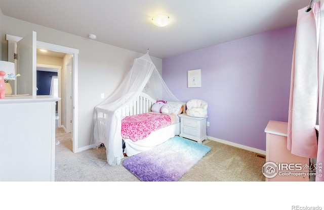 bedroom with baseboards and light colored carpet