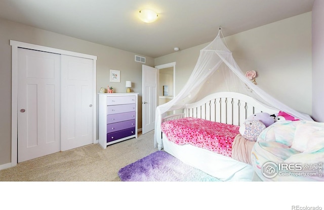 bedroom with light carpet, a closet, and visible vents