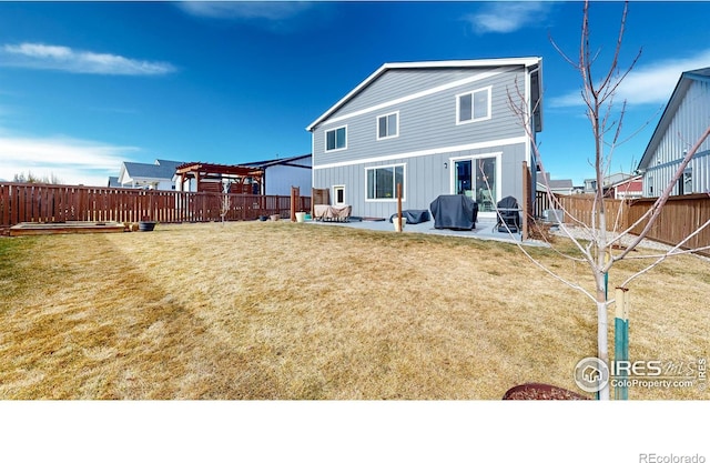 rear view of house with a patio, a lawn, a fenced backyard, and a pergola