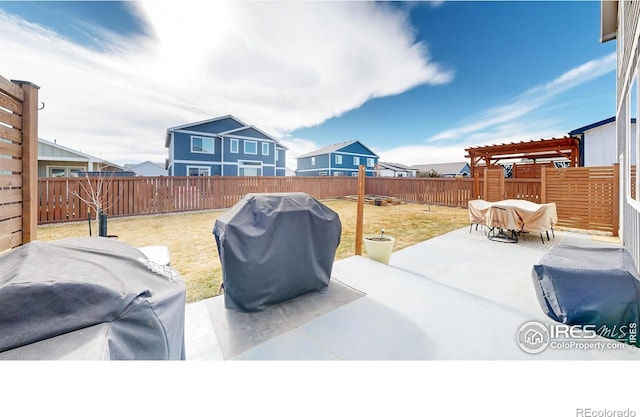 view of yard featuring a patio area, a fenced backyard, a residential view, and a pergola