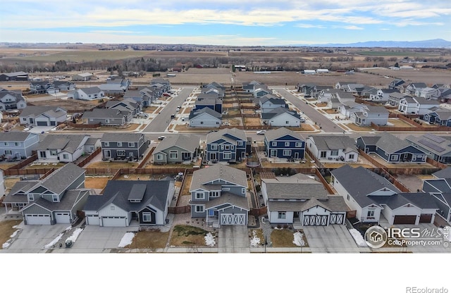 drone / aerial view featuring a residential view and a mountain view