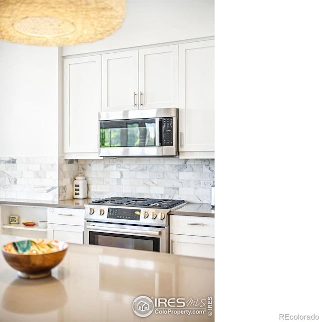 kitchen featuring white cabinetry, tasteful backsplash, and appliances with stainless steel finishes