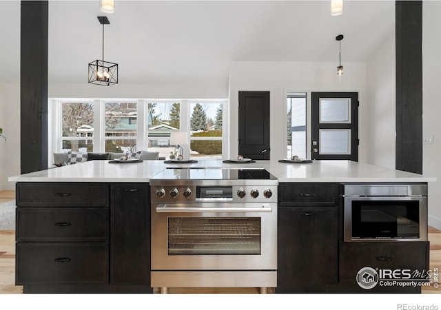 kitchen featuring hanging light fixtures, light hardwood / wood-style floors, and appliances with stainless steel finishes