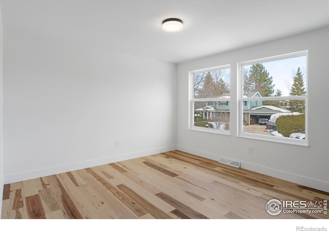 empty room with light hardwood / wood-style floors