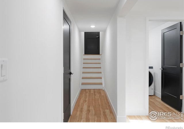 hallway featuring light wood-type flooring and washer / dryer