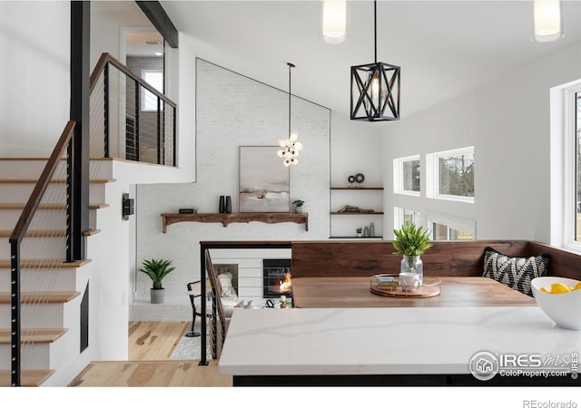 dining room with stairway, a high ceiling, and wood finished floors