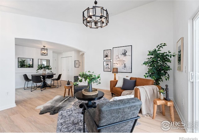 living room featuring light hardwood / wood-style floors and a chandelier