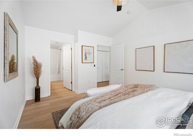 bedroom with lofted ceiling, ceiling fan, and light wood-type flooring