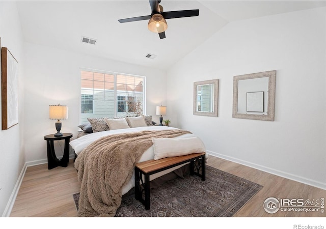 bedroom with vaulted ceiling, light hardwood / wood-style floors, and ceiling fan